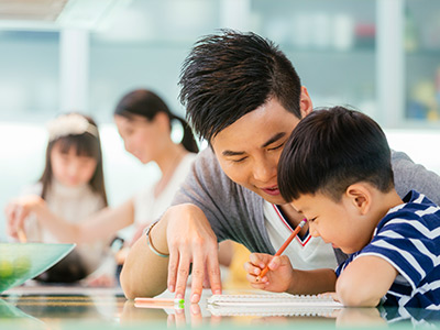 father helping his son with his homework