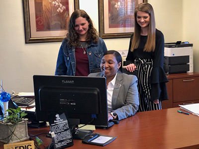 A banker showing students our online financial education program