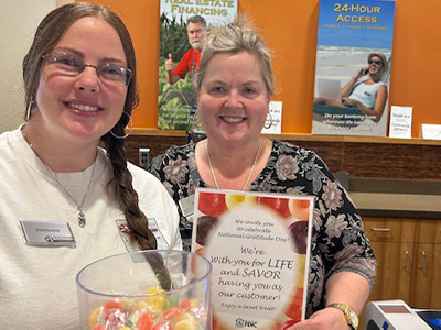 employees handing out candy on World Gratitude Day