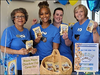 staff handing out treats to customers for national chocolate chip day