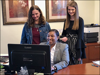 a branch manager showing the bank's financial education program to high school students
