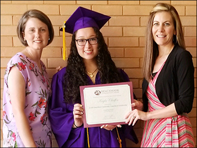 bankers presenting a scholarship to a high school senior