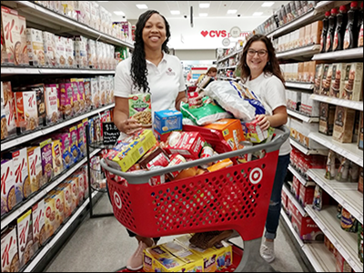 bankers shopping for items to donate for a food drive