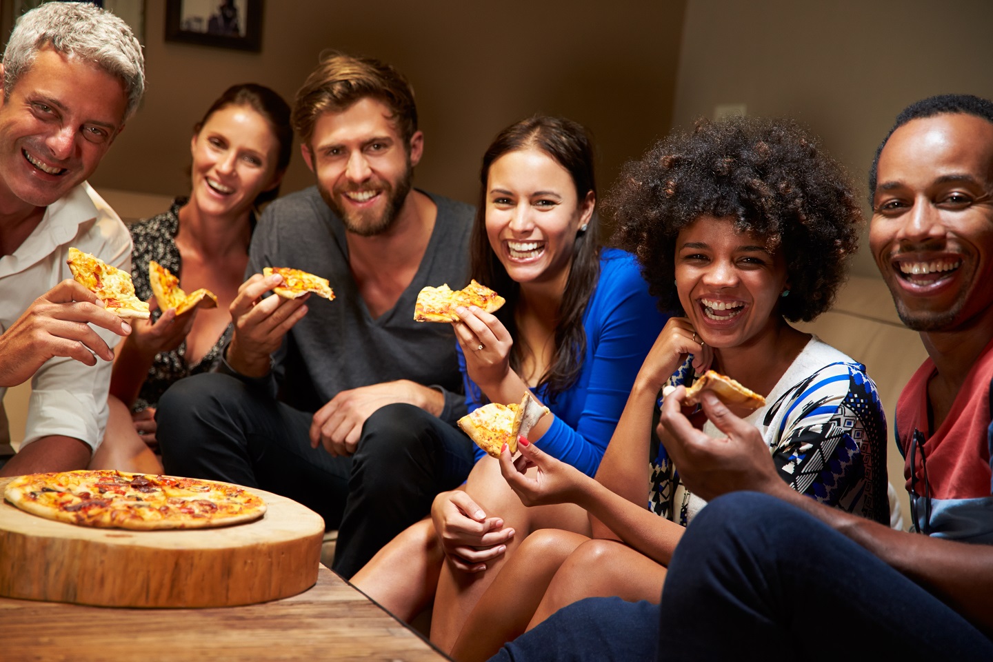 Group of friends eating pizza