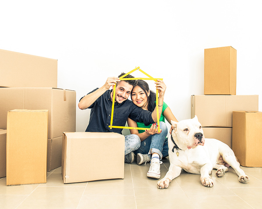 homeowners sitting with boxes ready to move into their new home