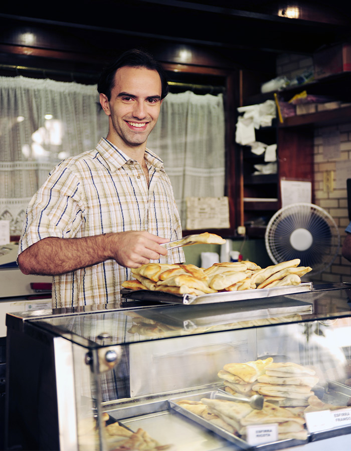 bakery owner replenishing the display case