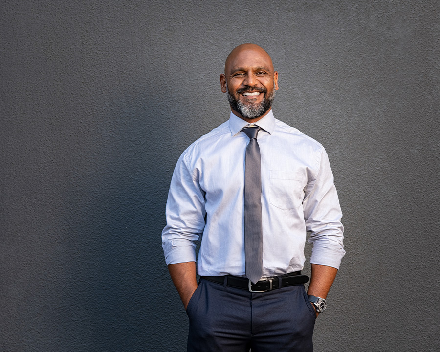 businessman standing with his hands in his pockets