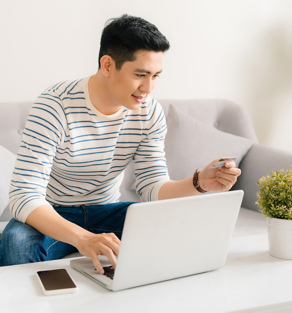 man using credit card and laptop
