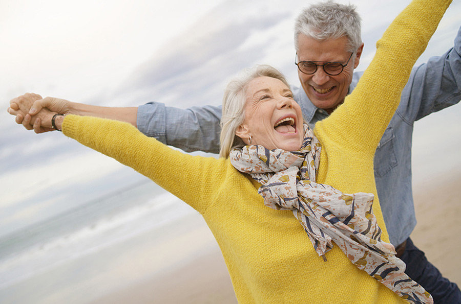 older couple having fun on the beach