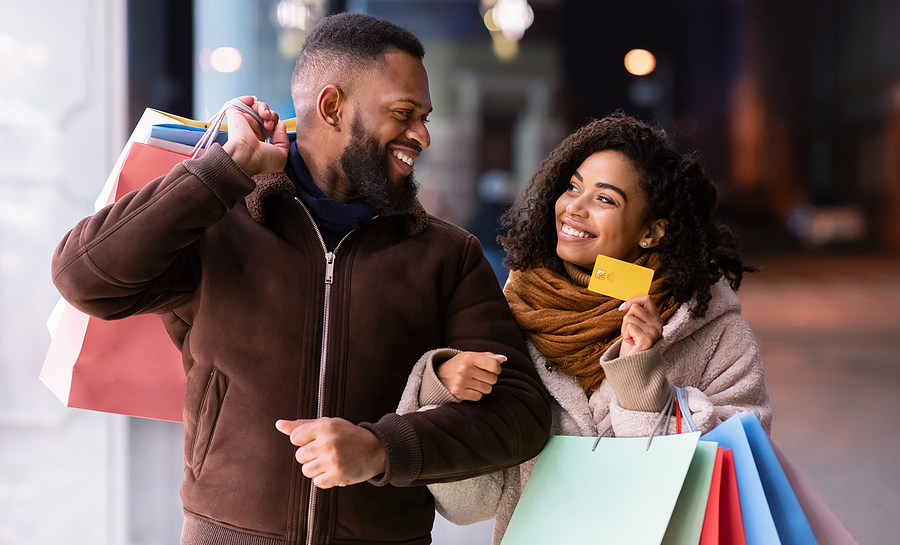 African-American man and woman smiling while shopping