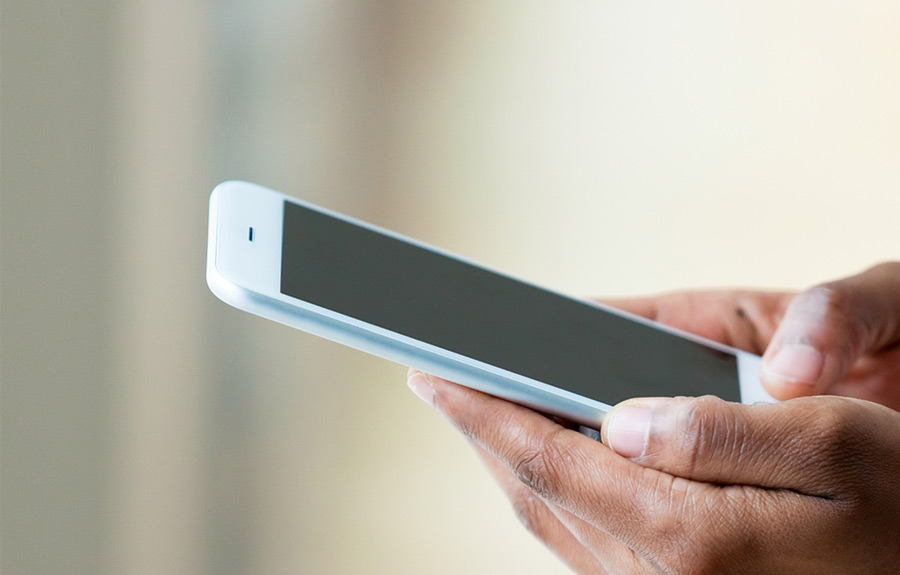 man sending a text on a mobile phone