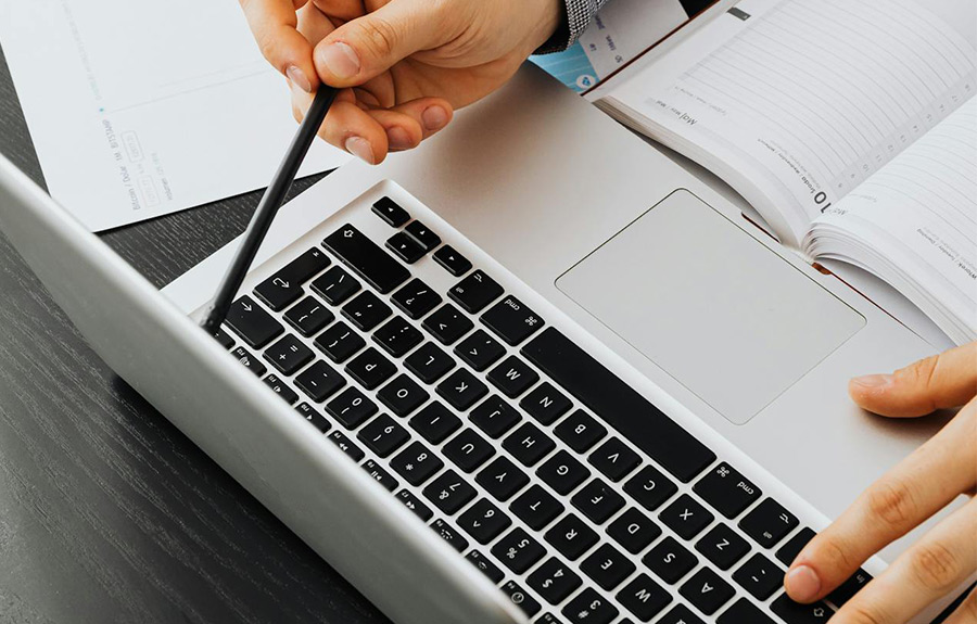 person sitting at a laptop reviewing information