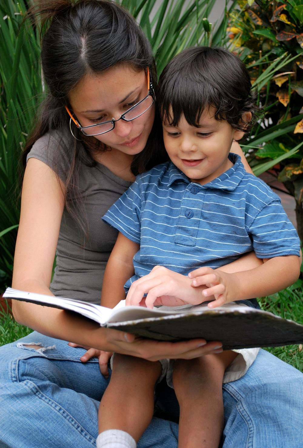 babysitter reading a little boy
