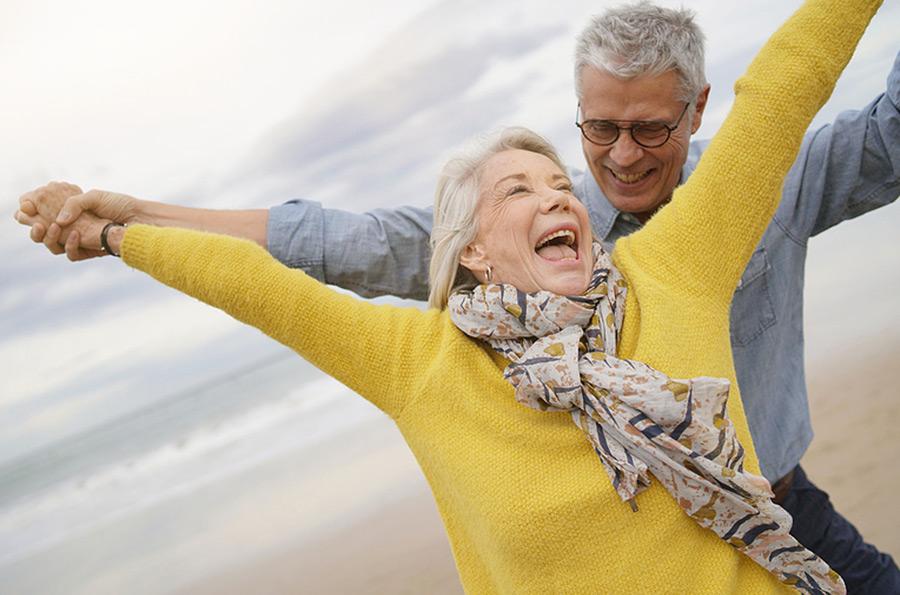 older couple having fun on the beach